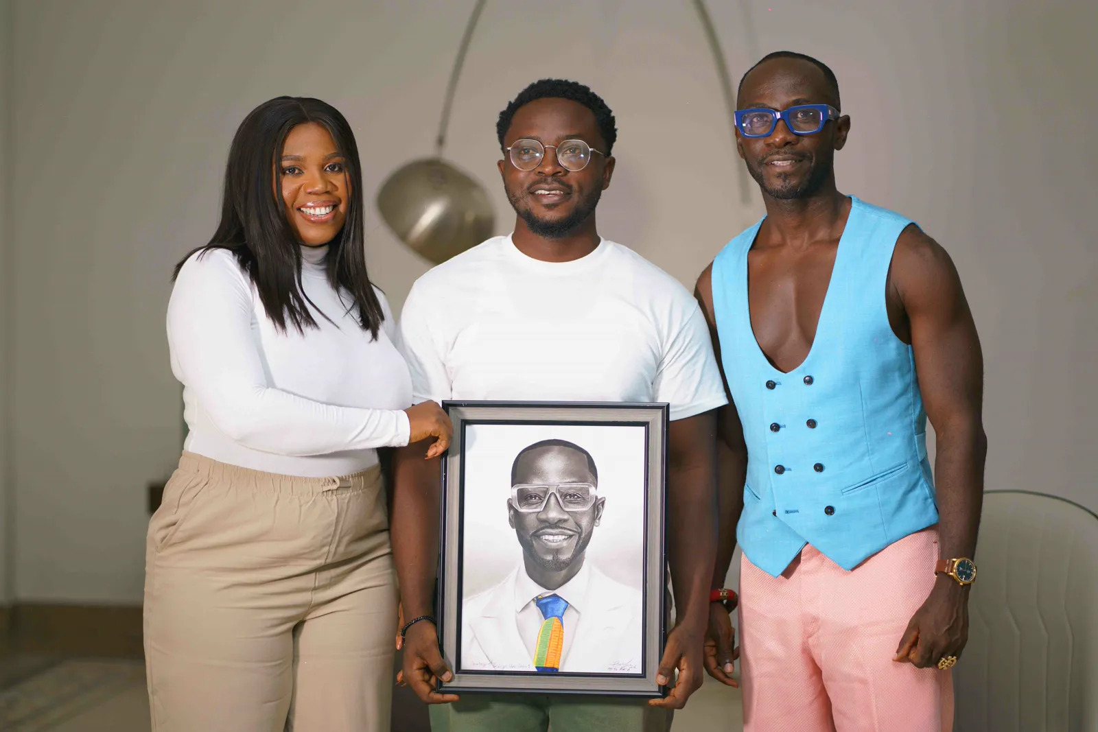 Okyeame Kwame and Lilian.A.Okafor Boateng proudly presenting custom hand-drawn fine-art portrait tribute on The Lily’s Show
